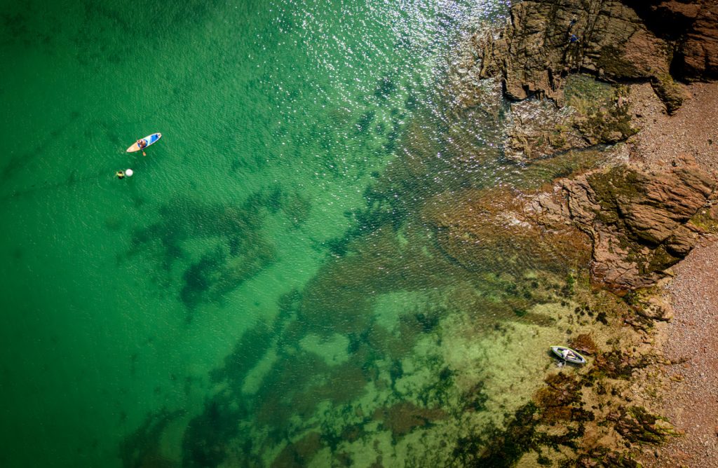 Paddleboarding on crystal sea by Richard Payton