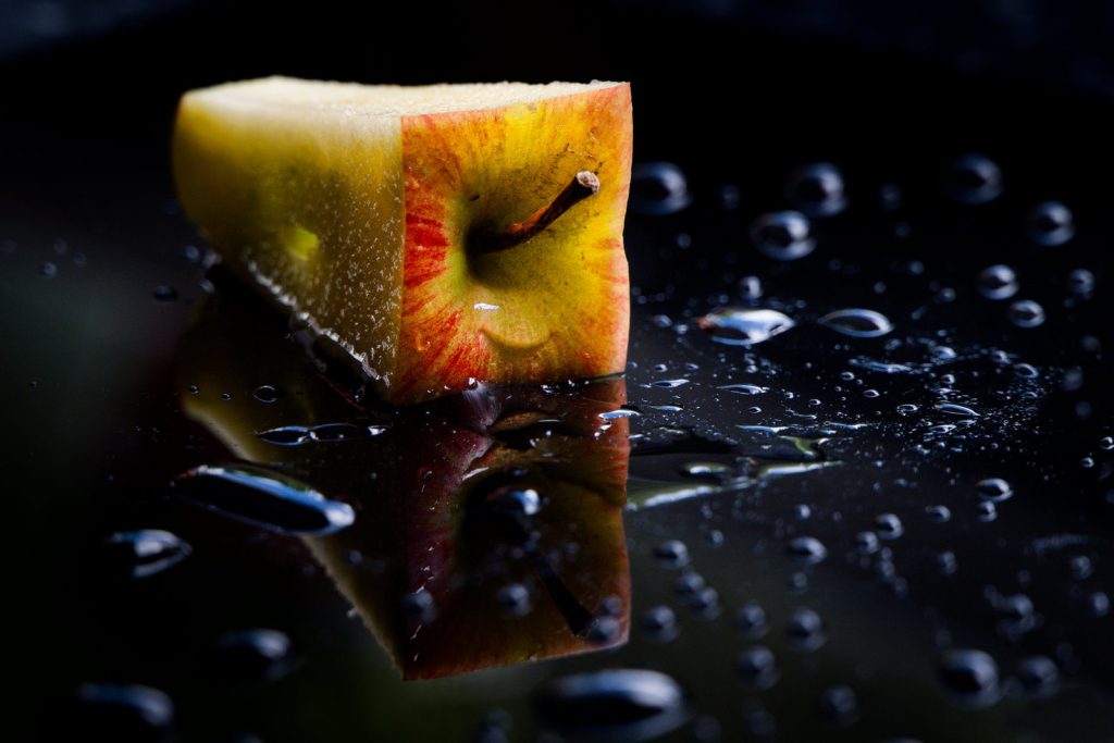 Still life with cut apple and water by Jeff Howe